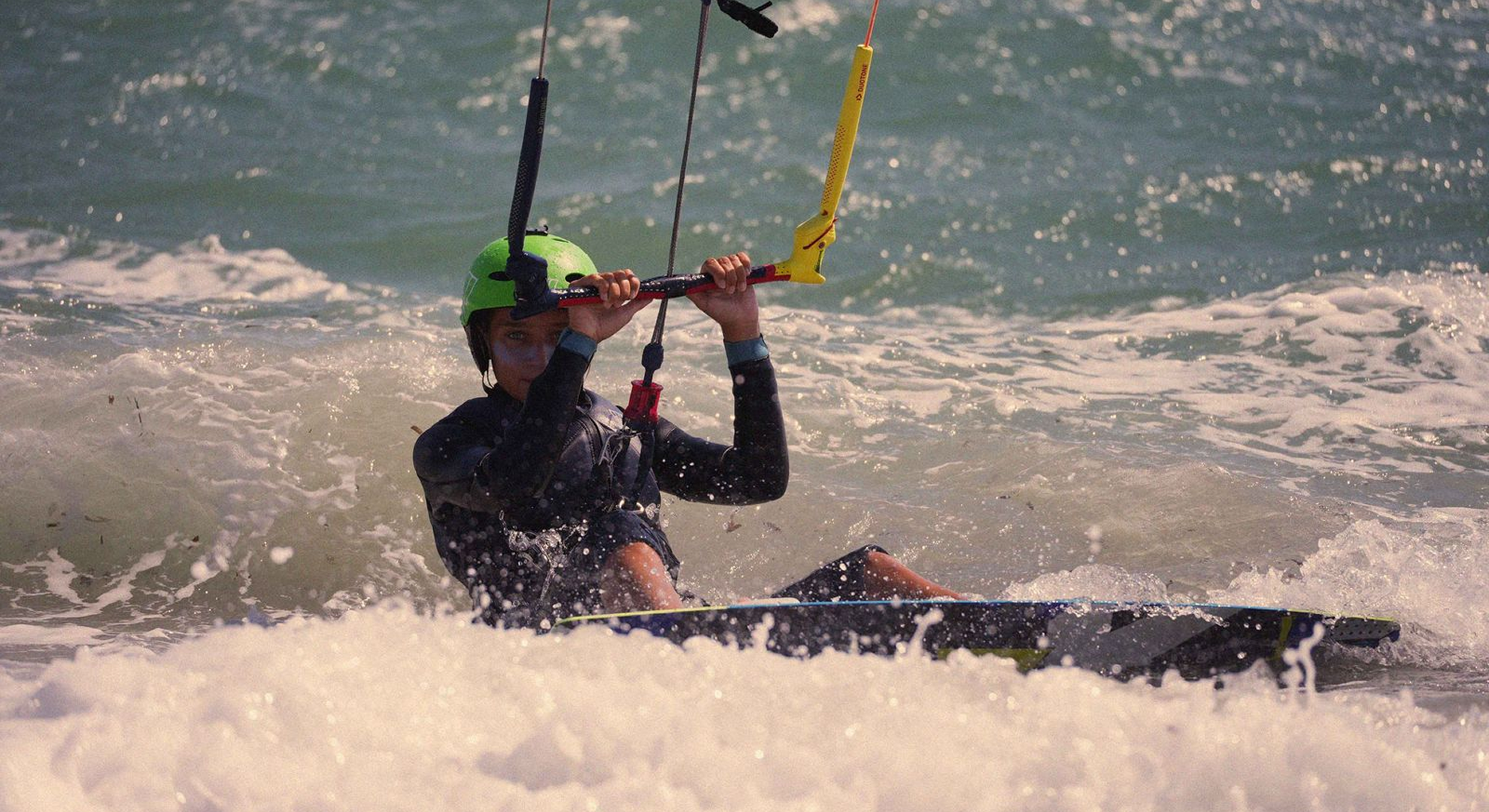 Aglika kitesurfing above the open sea